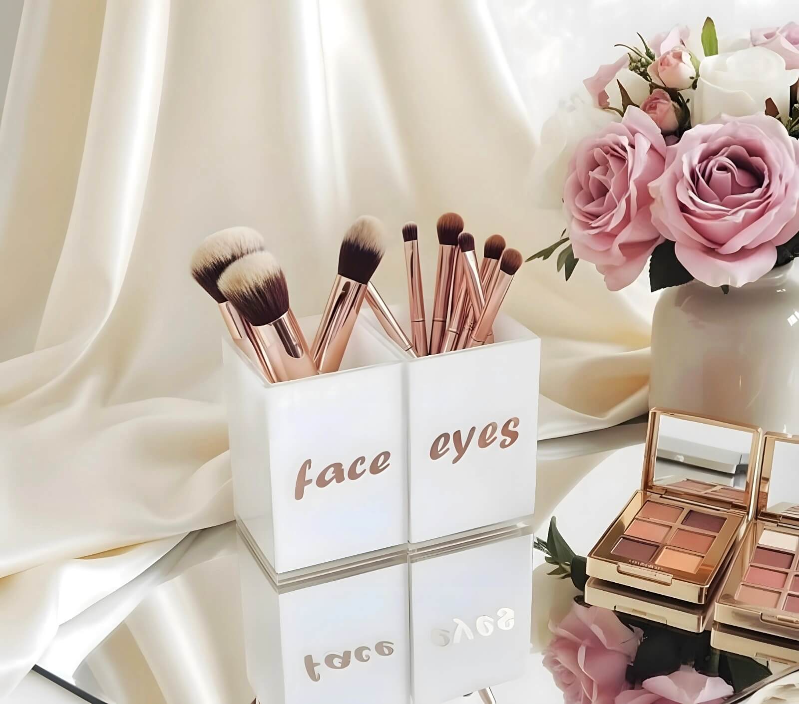 Face & Eyes brush set by Mirrorina on a mirror table with beige fabric backdrop, styled with a basket of flowers and eyeshadow palettes on the side.