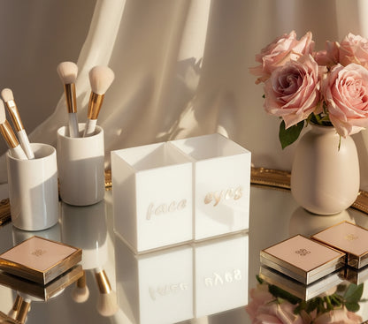 Face & Eyes brush set by Mirrorina on a mirrored stand with gold frame, styled with a vase of roses on the right, eyeshadow palettes around the set, and brushes in the background.